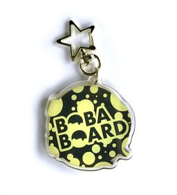 Acrylic charm detail of the reverse with the BobaBoard logo and the star clasp.